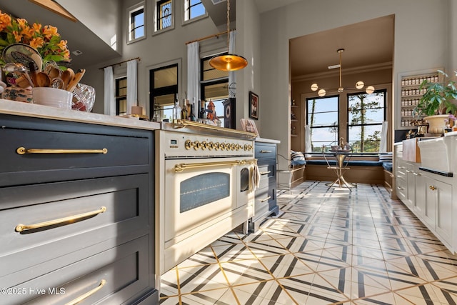 628 E Harborside Rd, Oriental, NC 28571 - kitchen featuring light tile patterned floors, ornamental molding, hanging light fixtures, white cabinetry, and light countertops