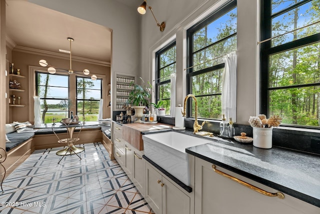 628 E Harborside Rd, Oriental, NC 28571 - kitchen featuring a sink, light tile patterned flooring, plenty of natural light, and white cabinets