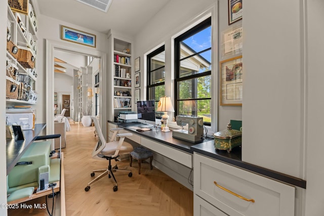 628 E Harborside Rd, Oriental, NC 28571 - home office featuring visible vents, plenty of natural light, and built in shelves