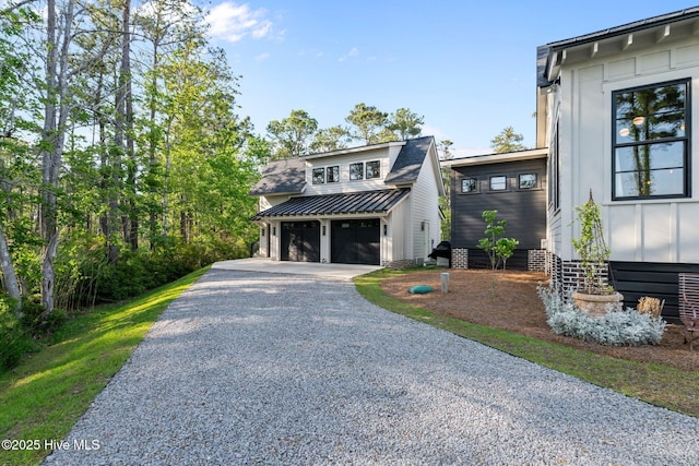 628 E Harborside Rd, Oriental, NC 28571 - view of front of house with board and batten siding, a garage, and driveway