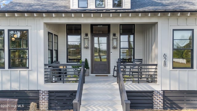 628 E Harborside Rd, Oriental, NC 28571 - entrance to property with a porch, a shingled roof, and board and batten siding
