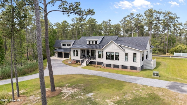 628 E Harborside Rd, Oriental, NC 28571 - view of front of home featuring a garage, board and batten siding, a front yard, a porch, and driveway
