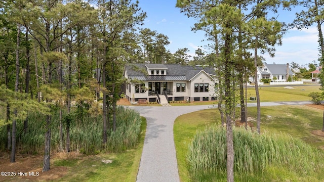 628 E Harborside Rd, Oriental, NC 28571 - view of front of property with covered porch, stairs, curved driveway, and a front lawn