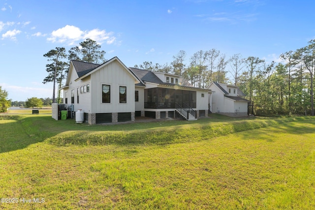 628 E Harborside Rd, Oriental, NC 28571 - rear view of property featuring a yard, a sunroom, and board and batten siding