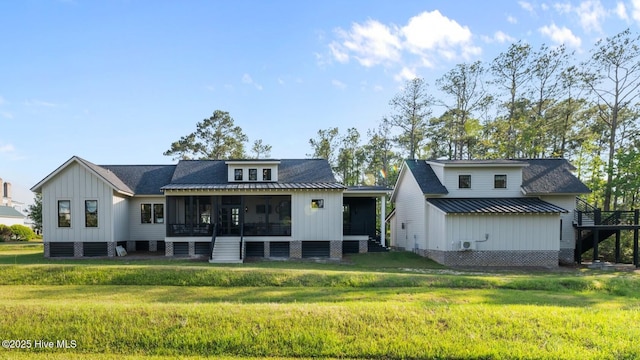 628 E Harborside Rd, Oriental, NC 28571 - rear view of property featuring a sunroom, a lawn, and board and batten siding