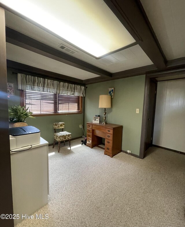 office with visible vents, baseboards, and light carpet