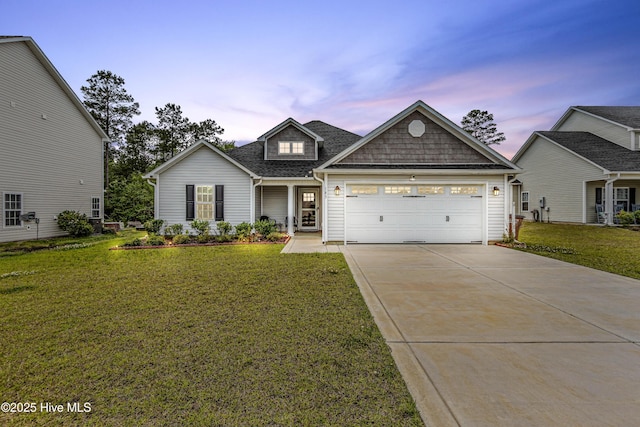 view of front of property featuring a lawn, driveway, and a garage