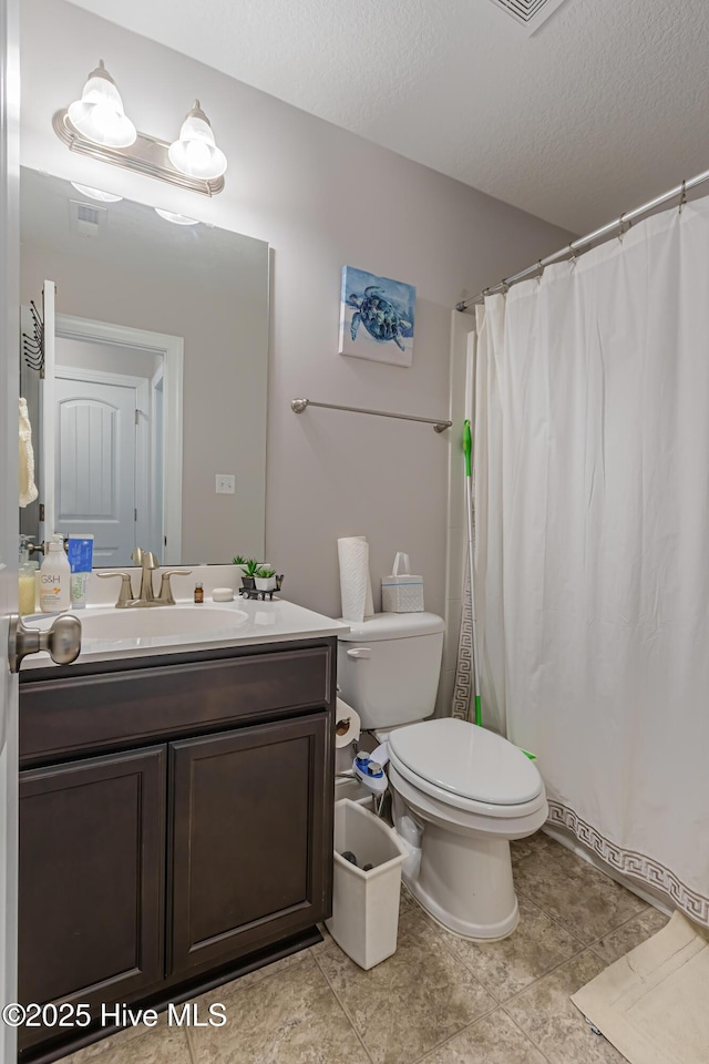 bathroom featuring a textured ceiling, visible vents, tile patterned flooring, vanity, and toilet