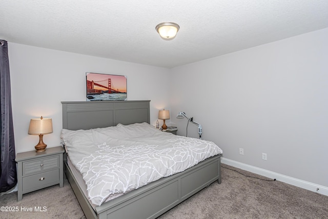 bedroom with baseboards and light carpet