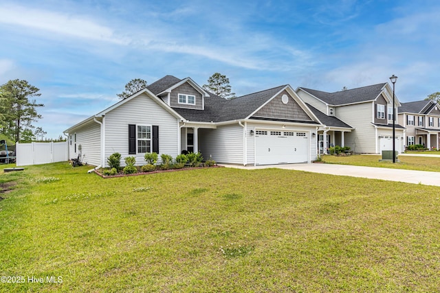 view of front facade with concrete driveway, fence, a front lawn, and a garage