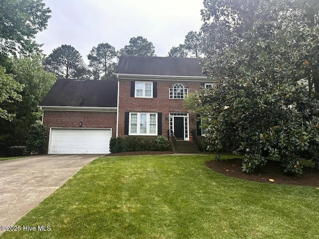 1601 Castalia Dr, Cary, NC 27513 - colonial inspired home featuring brick siding, concrete driveway, a front lawn, and an attached garage