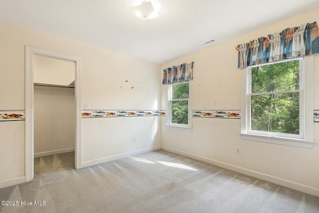 1601 Castalia Dr, Cary, NC 27513 - unfurnished bedroom with carpet flooring, a spacious closet, and baseboards