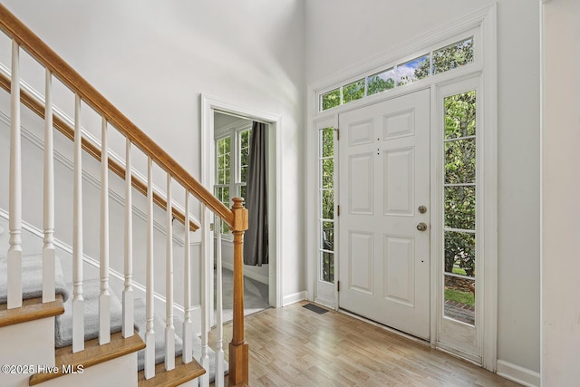 1601 Castalia Dr, Cary, NC 27513 - foyer featuring stairs, baseboards, and light wood-style flooring