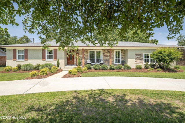 single story home with brick siding and a front yard