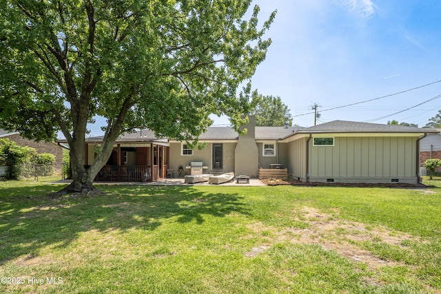 back of house featuring a patio, a yard, and crawl space