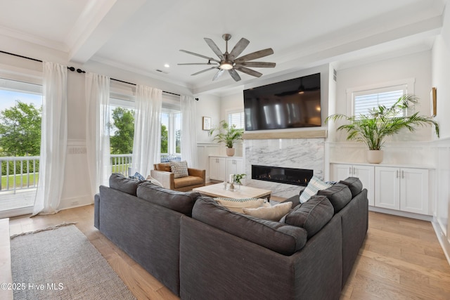 729 Waterstone Dr, Wilmington, NC 28411 - living room with a premium fireplace, ceiling fan, light wood-type flooring, a decorative wall, and beam ceiling