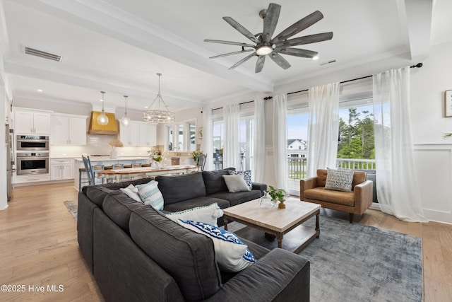 729 Waterstone Dr, Wilmington, NC 28411 - living room featuring ornamental molding, a ceiling fan, a chandelier, light wood-type flooring, and beam ceiling