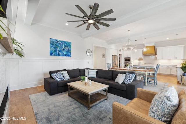 729 Waterstone Dr, Wilmington, NC 28411 - living area with light wood finished floors, ceiling fan, beamed ceiling, a decorative wall, and ornamental molding