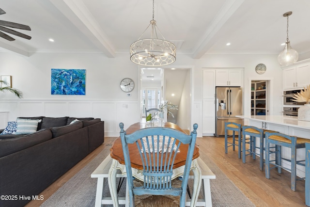 729 Waterstone Dr, Wilmington, NC 28411 - dining area with beamed ceiling, a ceiling fan, crown molding, light wood-style floors, and a chandelier