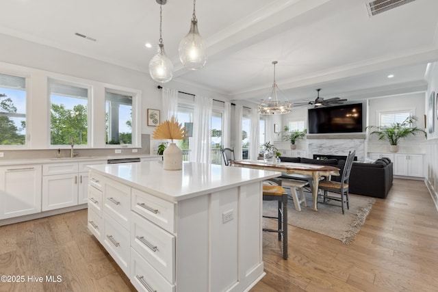 729 Waterstone Dr, Wilmington, NC 28411 - kitchen with a sink, white cabinetry, light countertops, pendant lighting, and a high end fireplace