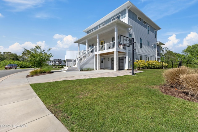 729 Waterstone Dr, Wilmington, NC 28411 - view of front facade featuring concrete driveway, a front lawn, covered porch, and stairs