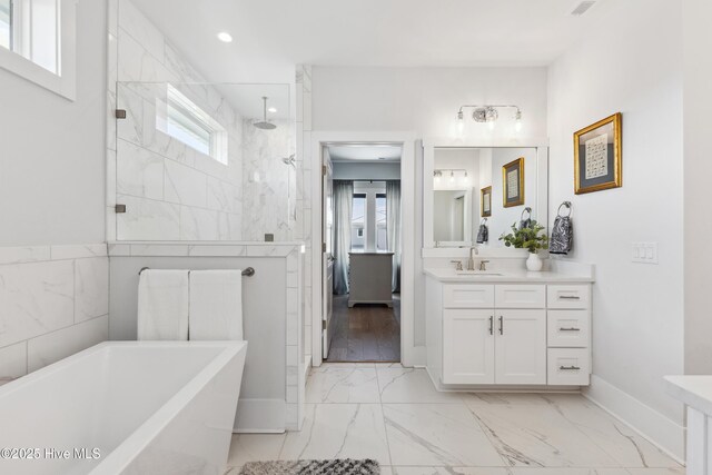 729 Waterstone Dr, Wilmington, NC 28411 - full bathroom with healthy amount of natural light, marble finish floors, a walk in shower, a freestanding bath, and recessed lighting
