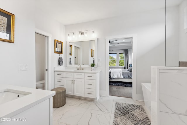 729 Waterstone Dr, Wilmington, NC 28411 - full bath featuring marble look tiles, two vanities, ensuite bath, toilet, and ceiling fan