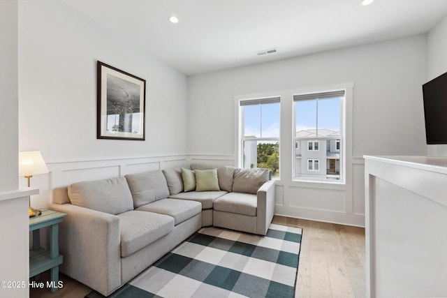 729 Waterstone Dr, Wilmington, NC 28411 - living room with wood finished floors, recessed lighting, a wainscoted wall, and a decorative wall