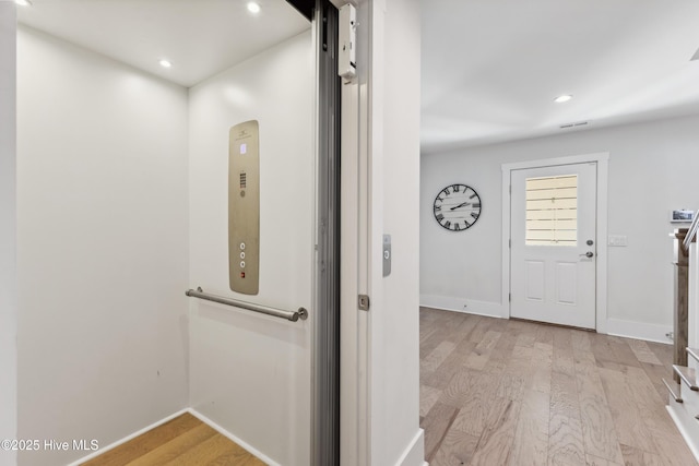 729 Waterstone Dr, Wilmington, NC 28411 - hall with elevator, light wood-type flooring, baseboards, and recessed lighting
