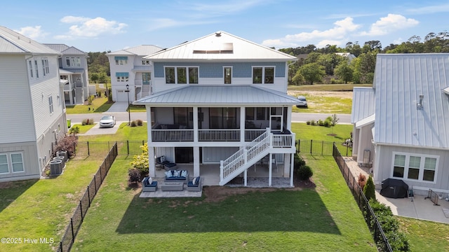 729 Waterstone Dr, Wilmington, NC 28411 - back of property with a sunroom, a patio, metal roof, and central AC