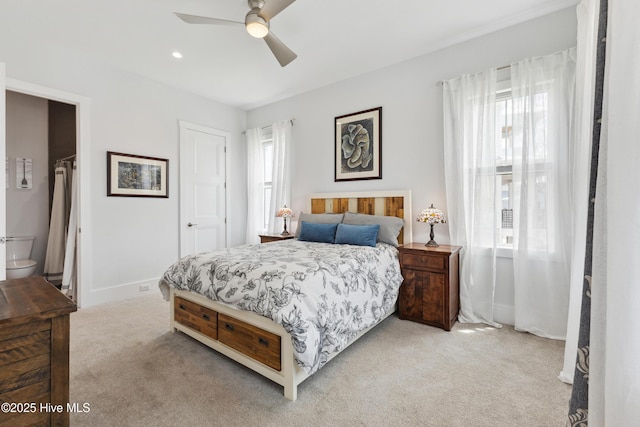 729 Waterstone Dr, Wilmington, NC 28411 - bedroom featuring light carpet, baseboards, connected bathroom, and a ceiling fan