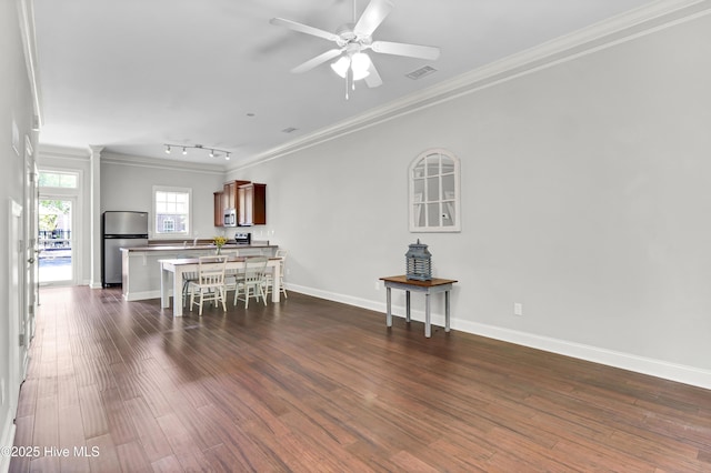 dining space with ceiling fan, dark wood-style flooring, visible vents, track lighting, and ornamental molding