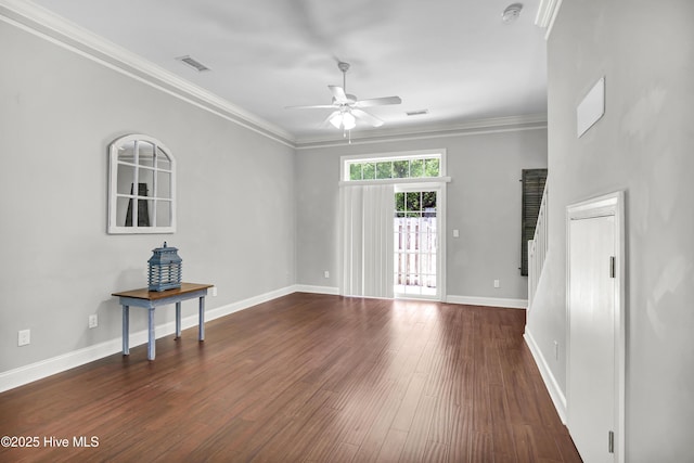 unfurnished living room with a ceiling fan, baseboards, dark wood-type flooring, visible vents, and ornamental molding