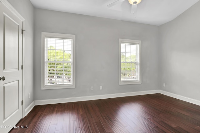 spare room featuring a ceiling fan, wood finished floors, and a healthy amount of sunlight