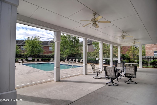 community pool featuring fence, ceiling fan, and a patio area