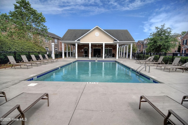 community pool featuring a patio and fence