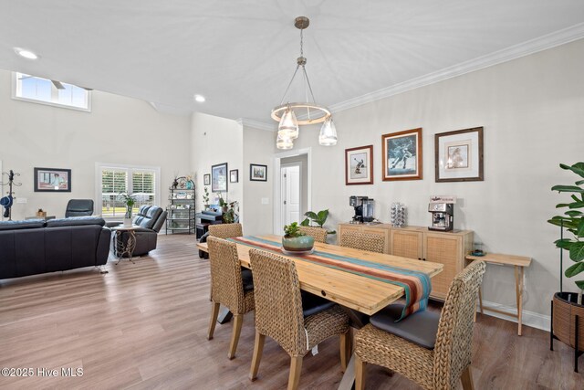 dining space with recessed lighting, baseboards, ornamental molding, and light wood-style floors