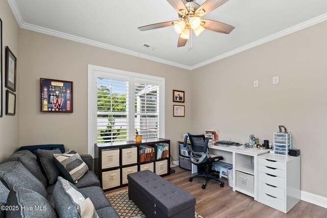 office area with ornamental molding, a ceiling fan, wood finished floors, and visible vents