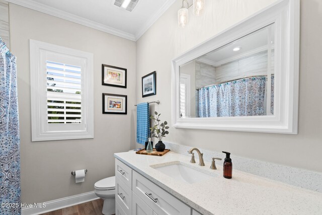 full bathroom featuring crown molding, vanity, toilet, wood finished floors, and visible vents