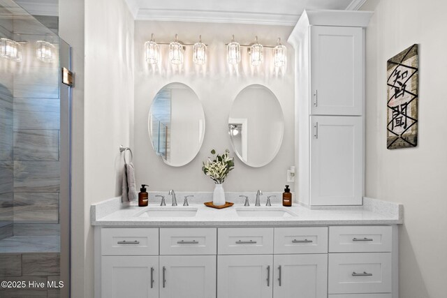 full bath with a sink, ornamental molding, a tile shower, and double vanity