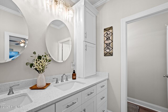 bathroom featuring double vanity, a sink, and ornamental molding