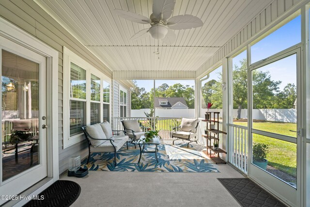 sunroom with plenty of natural light and a ceiling fan