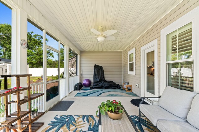 sunroom / solarium featuring ceiling fan