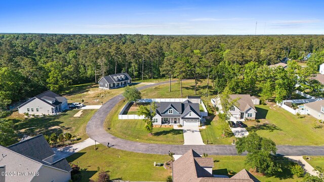 bird's eye view featuring a view of trees and a residential view