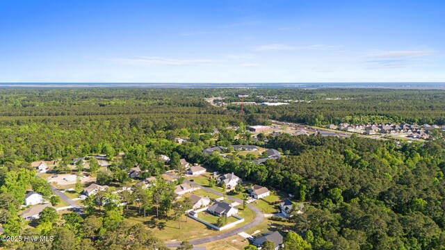 birds eye view of property featuring a residential view and a wooded view