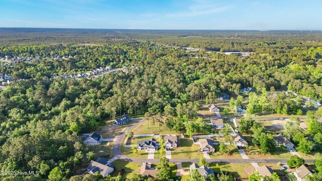 drone / aerial view featuring a residential view and a forest view