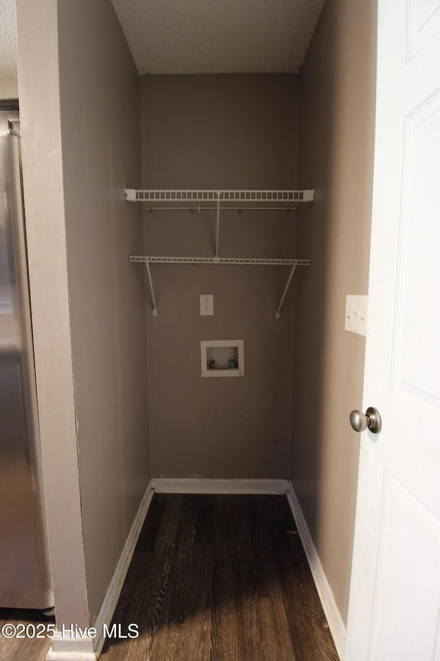 laundry area with washer hookup, baseboards, laundry area, and dark wood finished floors