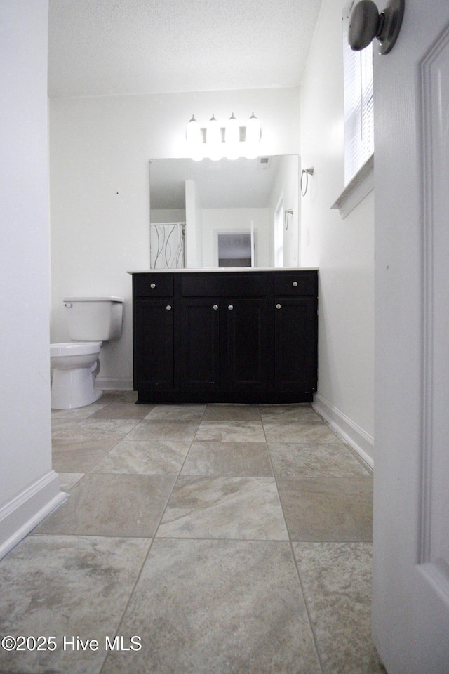205 S Creek Dr, Jacksonville, NC 28540 - bathroom with double vanity, baseboards, and toilet