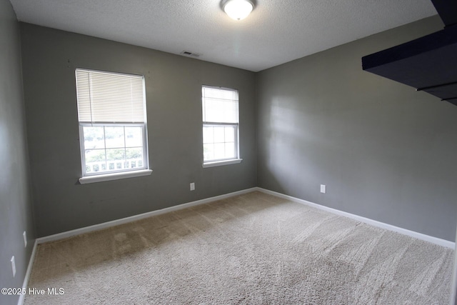 205 S Creek Dr, Jacksonville, NC 28540 - empty room featuring healthy amount of natural light, carpet, a textured ceiling, and baseboards