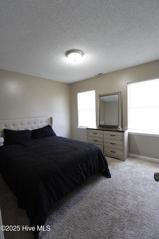 carpeted bedroom with a textured ceiling